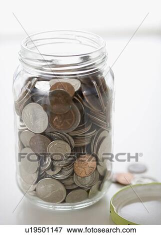 Stock Photo - Close up of mason jar with change. Fotosearch