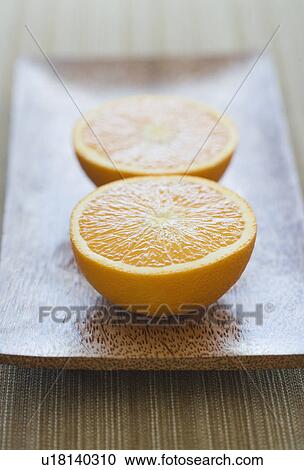 Close up of orange halves on plate View Large Photo Image Stock Image - Close up of orange halves on plate. Fotosearch