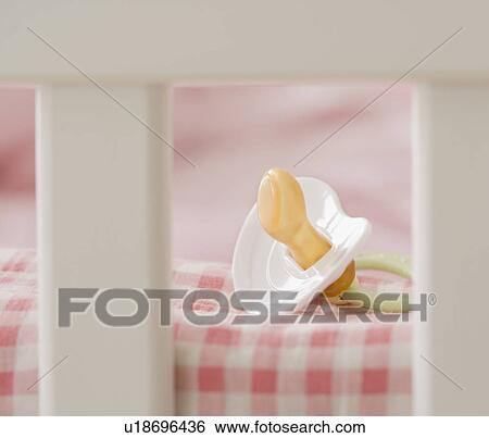 Close up of pacifier in crib View Large Photo Image Stock Photograph - Close up of pacifier in crib. Fotosearch