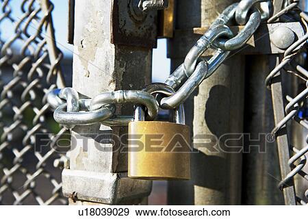 Close up of padlock on gate View Large Photo Image Stock Photo - Close up of padlock on gate. Fotosearch