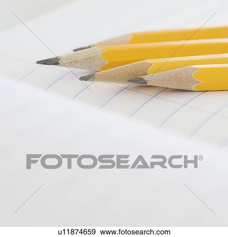 Stock Photo - Close up of pencils on notebook. Fotosearch