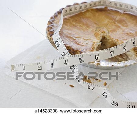 Close up of pie and tape measure View Large Photo Image Stock Photo - Close up of pie and tape measure. Fotosearch