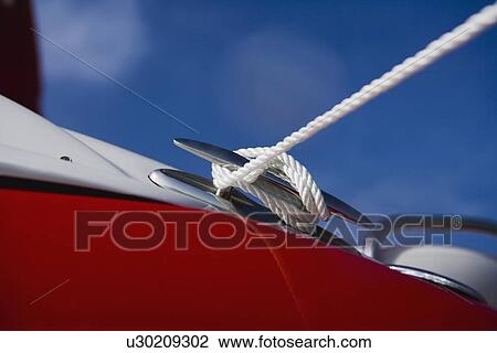 Stock Image - Close up of rope around boat cleat, Florida, United States. Fotosearch
