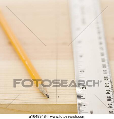 Picture - Close up of ruler and pencil on wood. Fotosearch