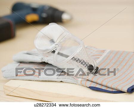 Picture - Close up of safety goggles and gloves. Fotosearch