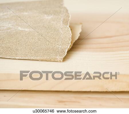 Stock Photograph - Close up of sandpaper on wood. Fotosearch