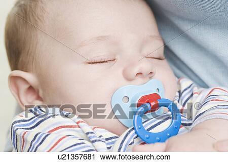 Close up of sleeping baby with pacifier View Large Photo Image Stock Image - Close up of sleeping baby with pacifier. Fotosearch