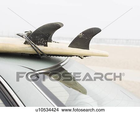 Close up of surfboard on top of car at beach View Large Photo Image Picture - Close up of surfboard on top of car at beach. Fotosearch