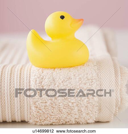 Stock Image - Close up of toy duck on towel. Fotosearch