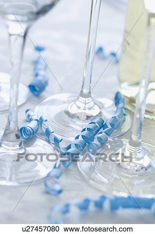 Stock Image - Close up of wine glasses and curled ribbon. Fotosearch