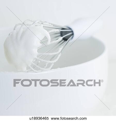 Stock Photography - Close up of wire whisk with batter. Fotosearch