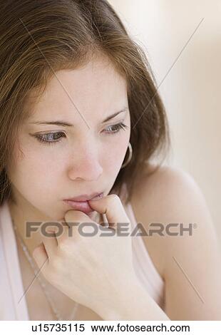 Close up of woman biting thumb View Large Photo Image Stock Photography - Close up of woman biting thumb. Fotosearch
