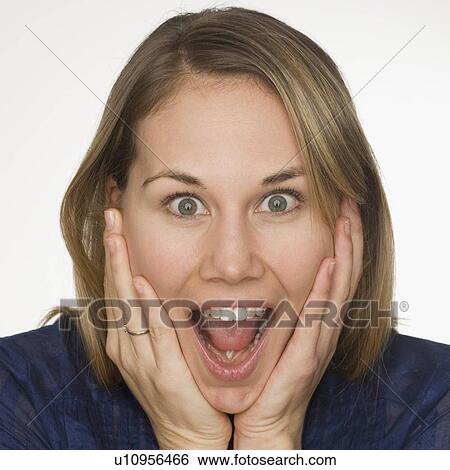 Stock Photograph - Close up of woman looking surprised. Fotosearch