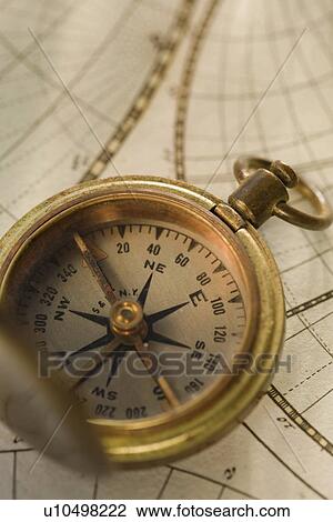 Stock Image - Compass on antique map. Fotosearch