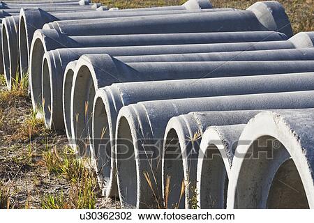 Concrete pipes on ground View Large Photo Image Stock Image - Concrete pipes on ground. Fotosearch