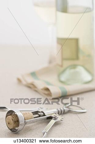 Corkscrew with bottle of white wine View Large Photo Image Stock Image - Corkscrew with bottle of white wine. Fotosearch