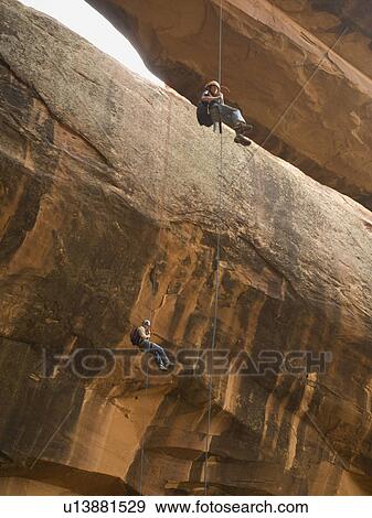 Couple canyon rappelling View Large Photo Image Stock Photo - Couple canyon rappelling. Fotosearch