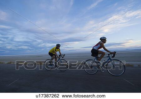 Couple cycling on road, Utah, United States View Large Photo Image Stock Image - Couple cycling on road, Utah, United States. Fotosearch