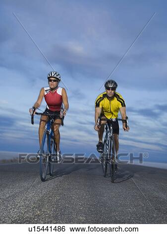 Couple cycling on road, Utah, United States View Large Photo Image Stock Photograph - Couple cycling on road, Utah, United States. Fotosearch