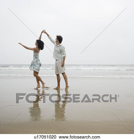 Couple dancing on beach View Large Photo Image Stock Image - Couple dancing on beach. Fotosearch