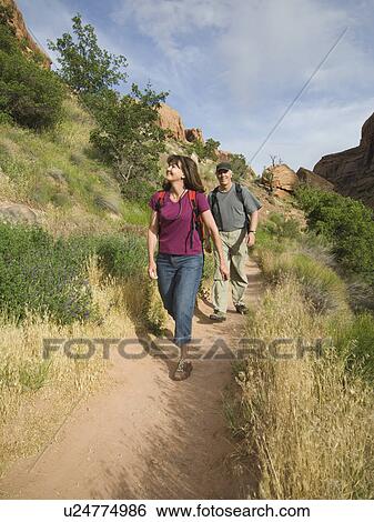 Stock Photograph - Couple hiking in desert. Fotosearch