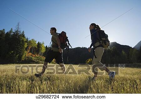 Picture - Couple hiking with backpacks, Utah, United States. Fotosearch