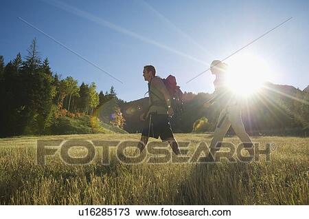 Couple hiking with backpacks, Utah, United States View Large Photo Image Stock Image - Couple hiking with backpacks, Utah, United States. Fotosearch