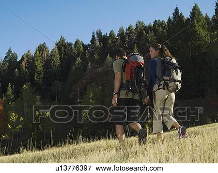 Couple hiking with backpacks, Utah, United States View Large Photo Image Stock Photo - Couple hiking with backpacks, Utah, United States. Fotosearch