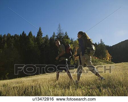 Couple hiking with backpacks, Utah, United States View Large Photo Image Stock Photograph - Couple hiking with backpacks, Utah, United States. Fotosearch