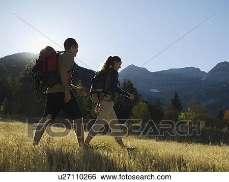 Stock Photograph - Couple hiking with backpacks, Utah, United States. Fotosearch