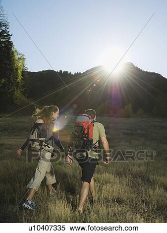 Stock Photography - Couple hiking with backpacks, Utah, United States. Fotosearch