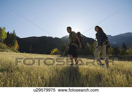 Stock Photography - Couple hiking with backpacks, Utah, United States. Fotosearch