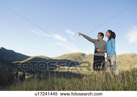 Couple holding binoculars and pointing, Utah, United States View Large Photo Image Stock Photography - Couple holding binoculars and pointing, Utah, United States. Fotosearch