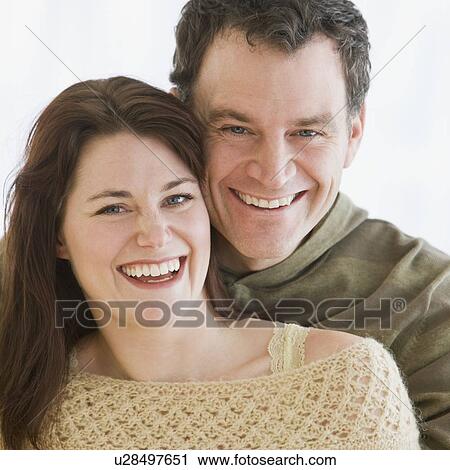 Couple hugging and laughing View Large Photo Image Stock Image - Couple hugging and laughing. Fotosearch