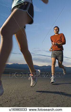 Couple in athletic gear running View Large Photo Image Stock Image - Couple in athletic gear running. Fotosearch
