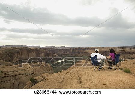 Couple in camping chairs over-looking canyon View Large Photo Image Picture - Couple in camping chairs over-looking canyon. Fotosearch