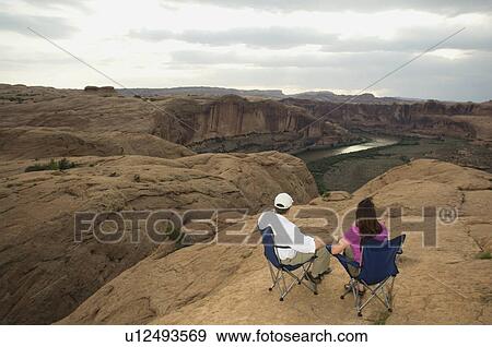 Couple in camping chairs over-looking canyon View Large Photo Image Stock Photo - Couple in camping chairs over-looking canyon. Fotosearch