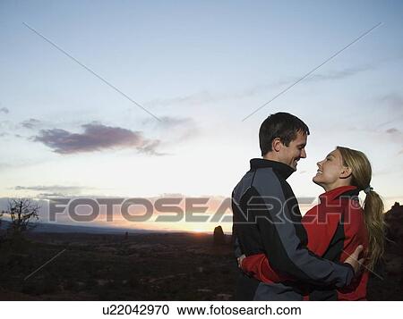 Couple in desert at dusk View Large Photo Image Stock Image - Couple in desert at dusk. Fotosearch