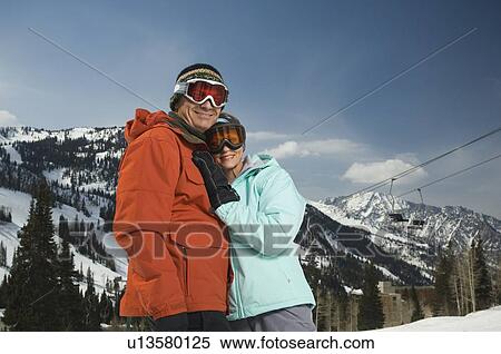 Stock Photography - Couple in ski gear hugging. Fotosearch