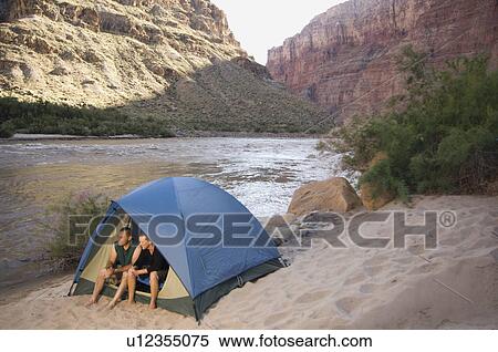 Couple in tent next to river, Colorado River, Moab, Utah, United States View Large Photo Image Stock Photography - Couple in tent next to river, Colorado River, Moab, Utah, United States. Fotosearch