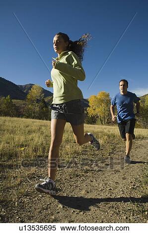 Stock Photography - Couple jogging on trail, Utah, United States. Fotosearch