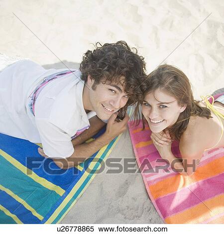 Couple laying on beach towels View Large Photo Image Stock Photography - Couple laying on beach towels. Fotosearch