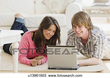 Couple looking at laptop View Large Photo Image Stock Image - Couple looking at laptop. Fotosearch