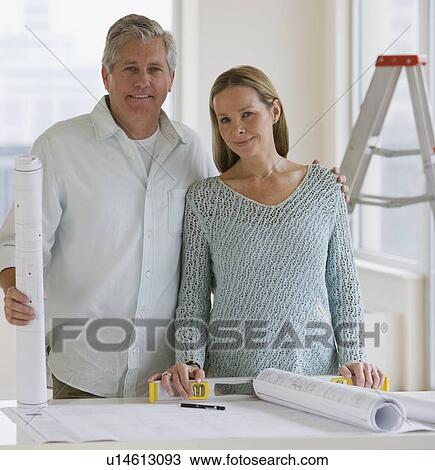 Couple next to blueprints View Large Photo Image Stock Image - Couple next to blueprints. Fotosearch