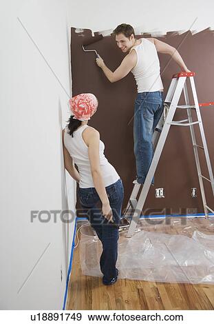 Couple painting indoors View Large Photo Image Stock Photo - Couple painting indoors. Fotosearch