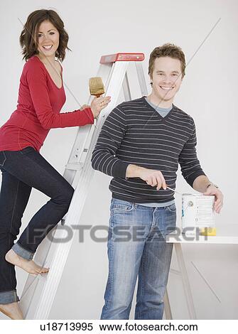 Stock Photography - Couple painting indoors. Fotosearch
