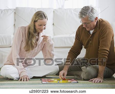 Stock Image - Couple playing board game. Fotosearch