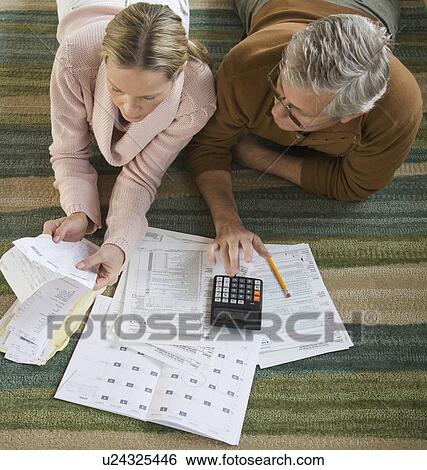 Couple preparing taxes View Large Photo Image Stock Photograph - Couple preparing taxes. Fotosearch