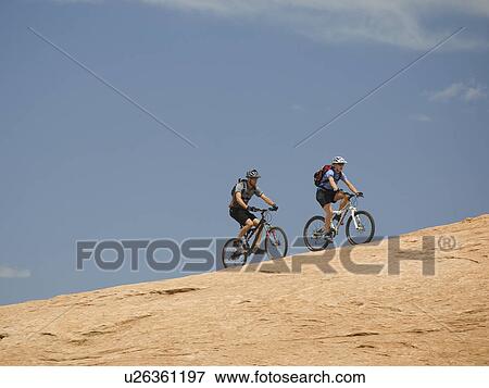 Couple riding mountain bikes in desert View Large Photo Image Stock Photo - Couple riding mountain bikes in desert. Fotosearch