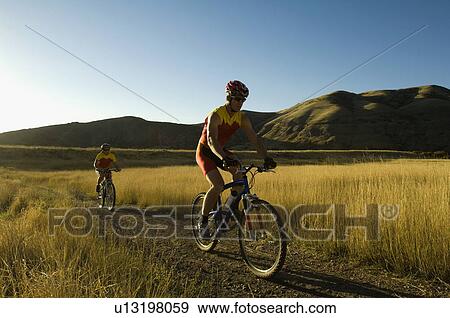 Couple riding mountain bikes, Salt Flats, Utah, United States View Large Photo Image Stock Photo - Couple riding mountain bikes, Salt Flats, Utah, United States. Fotosearch